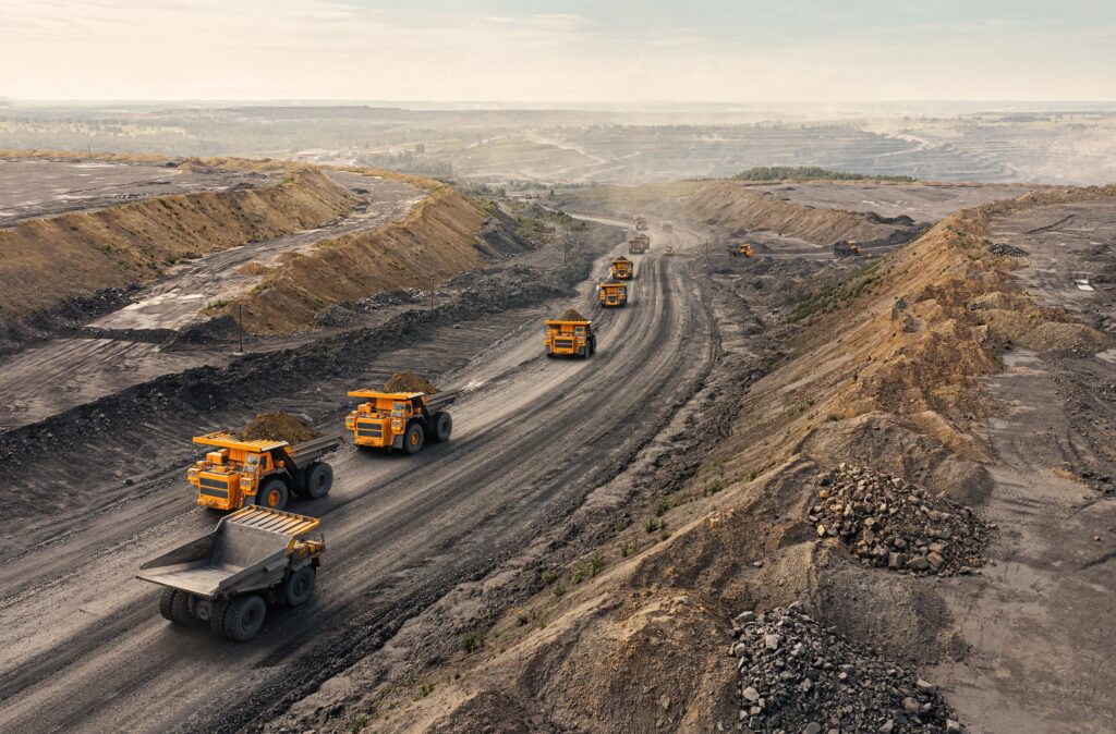 Large quarry dump trucks transporting ore.