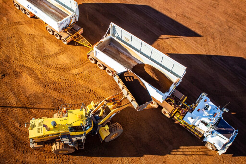 Loader loading a semi-trailer with iron ore.