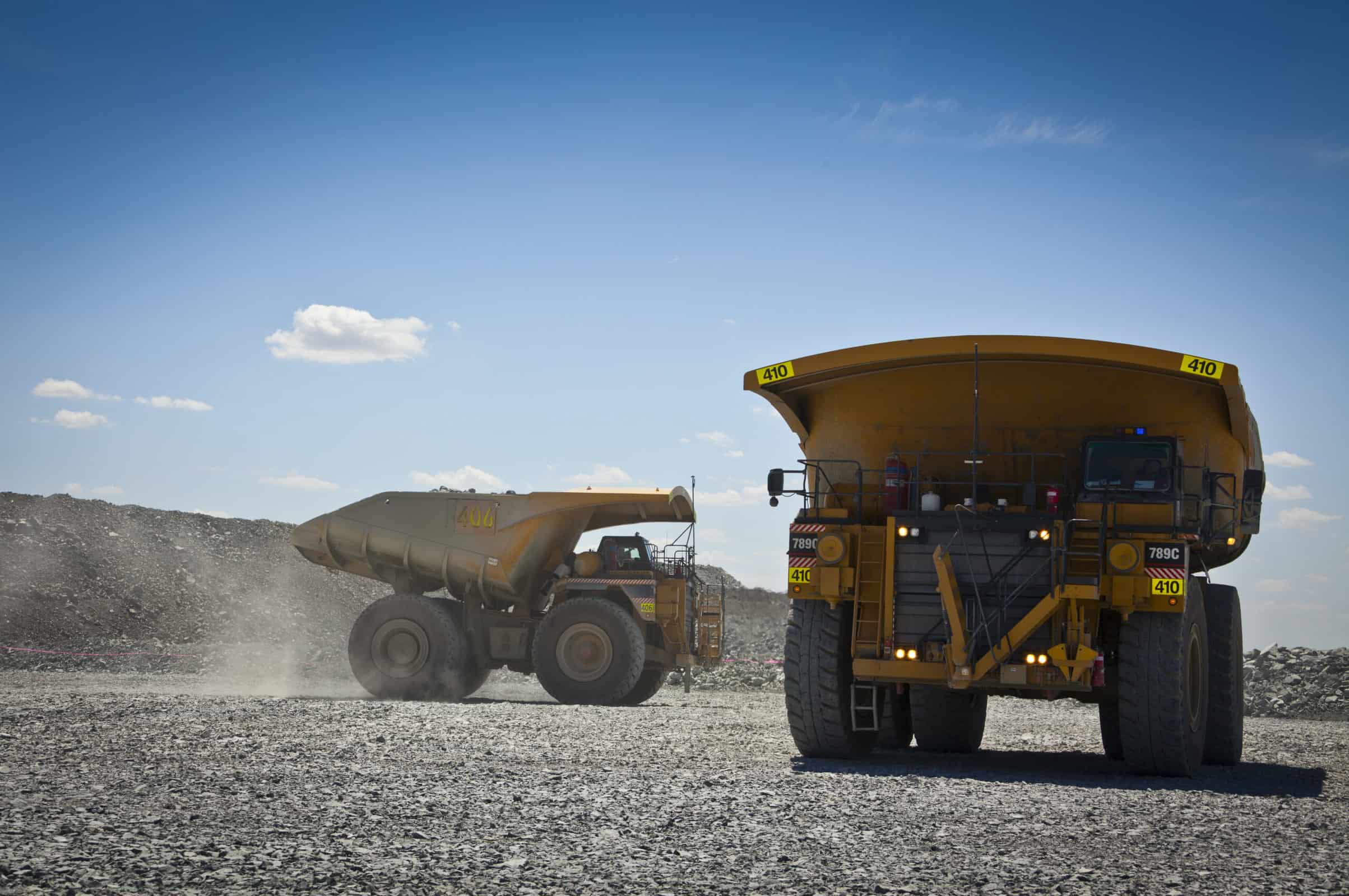 Novecom - Large trucks transport gold ore from open cast mine. Barrick Cowal Gold Mine in New South Wales, Australia.