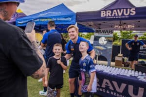 Cowboys star Tom Dearden posing with fans at the Community Day