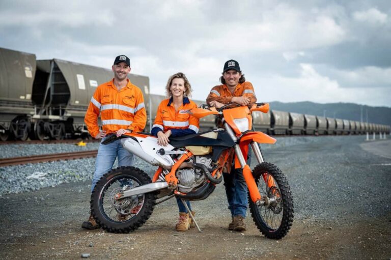 (Image source: Bravus) (L-R) Bowen Rail Company (BRC) general manager Brendan Lane, Don River Dash secretary Wanita Sparr, and BRC rollingstock maintainer Trent Williams at BRC’s rail provisioning yard north of Bowen’s Don River.