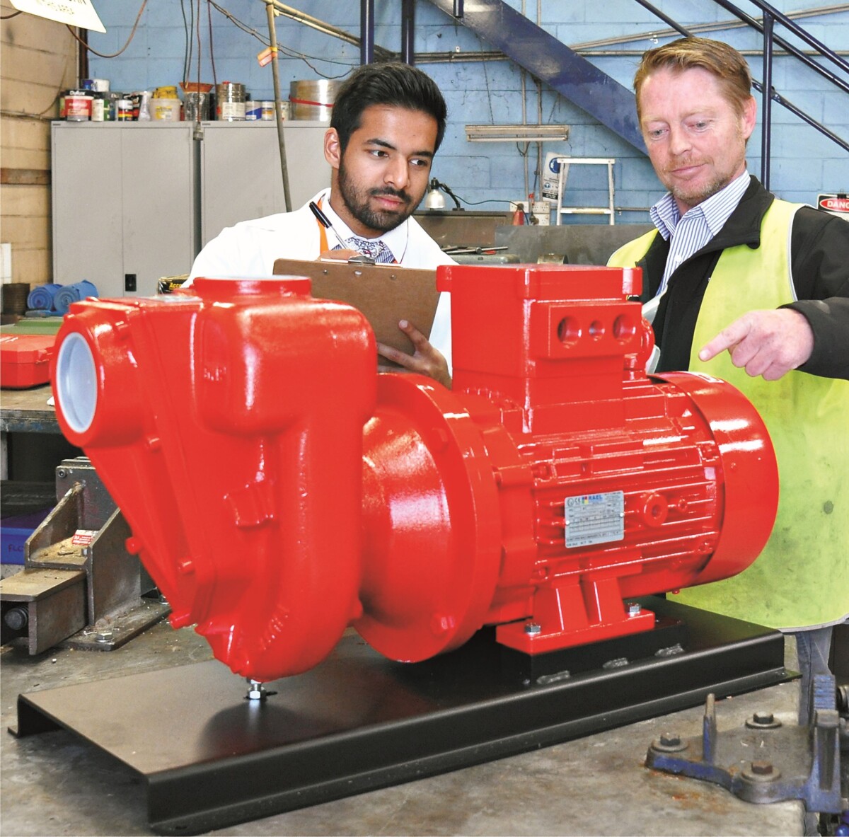 Red ATEX rated motors fitted to industrial pumps used for diesel fuel transfer.