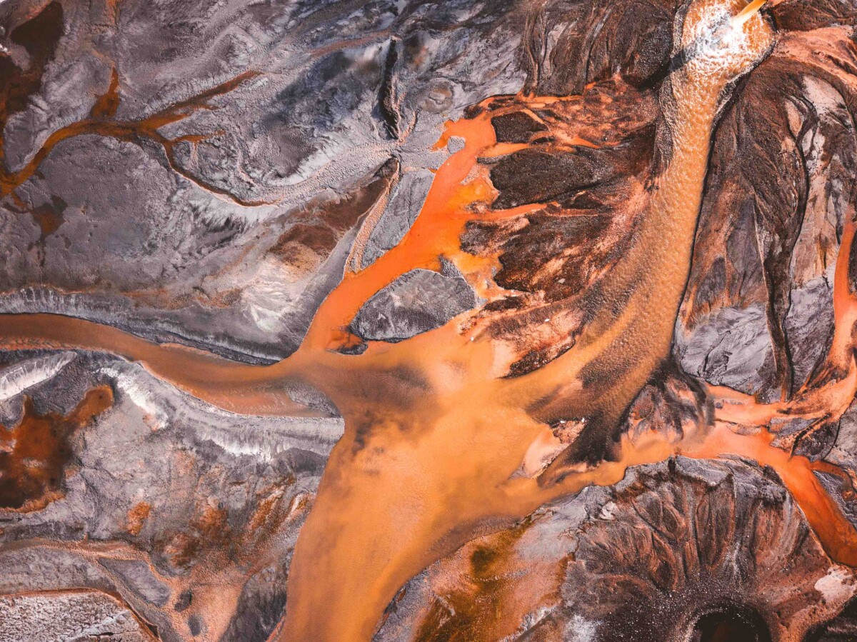 Aerial view of coal ash slurry from a thermal power plant flowing in to a storage lake.