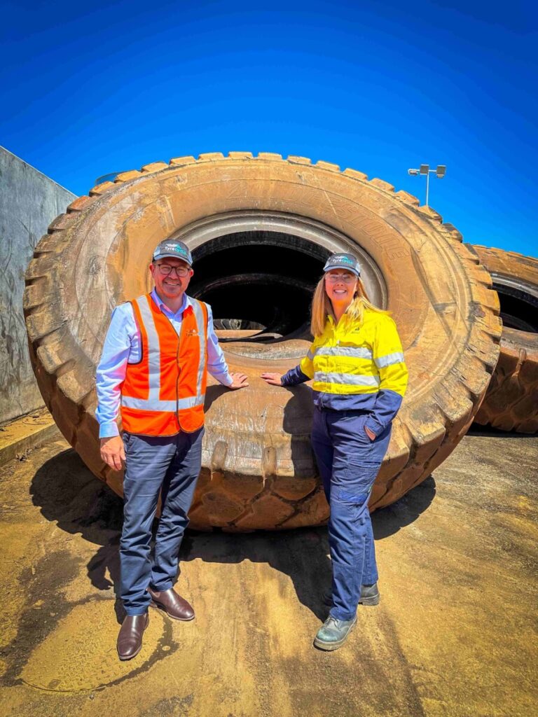 (Image source: Alcoa Australia) Tyrecycle chief executive Jim Fairweather and Alcoa’s Nicole King with the first of the Alcoa OTR tyres to be recycled at the Rockingham facility.