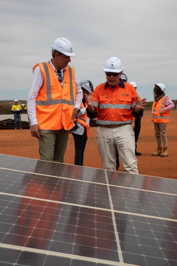 (Image source: Hard Hat Media) WA Energy Minister Reece Whitby and Zenith Energy chairman Doug Walker examine one of the 30,780 solar panels deployed at Liontown.