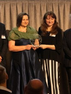 (Image source: SMI/UQ) Associate Professor Liza Forbes (left) and Associate Professor Kym Runge (right) receiving the Innovative Partnerships Award at the UQ Research Partnerships and Translation Awards.