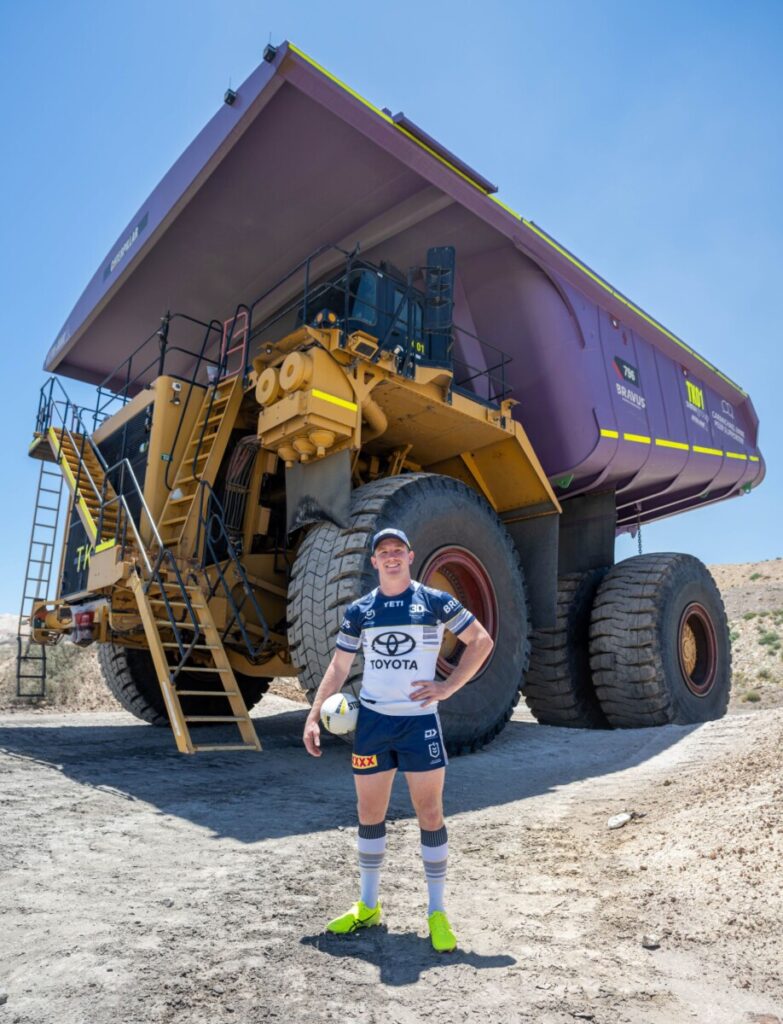 (Image source: Bravus Mining and Resources) Cowboys co-captain Tom Dearden in front of his haul truck ride.