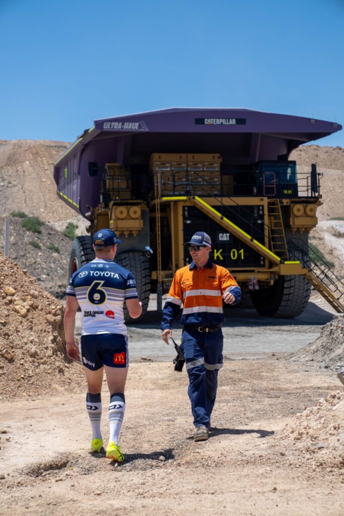 (Image source: Bravus Mining and Resources) Dearden catching the keys to the haul truck from Bravus Mining and Resources’ Sam Wilson in a scene from the television campaign.