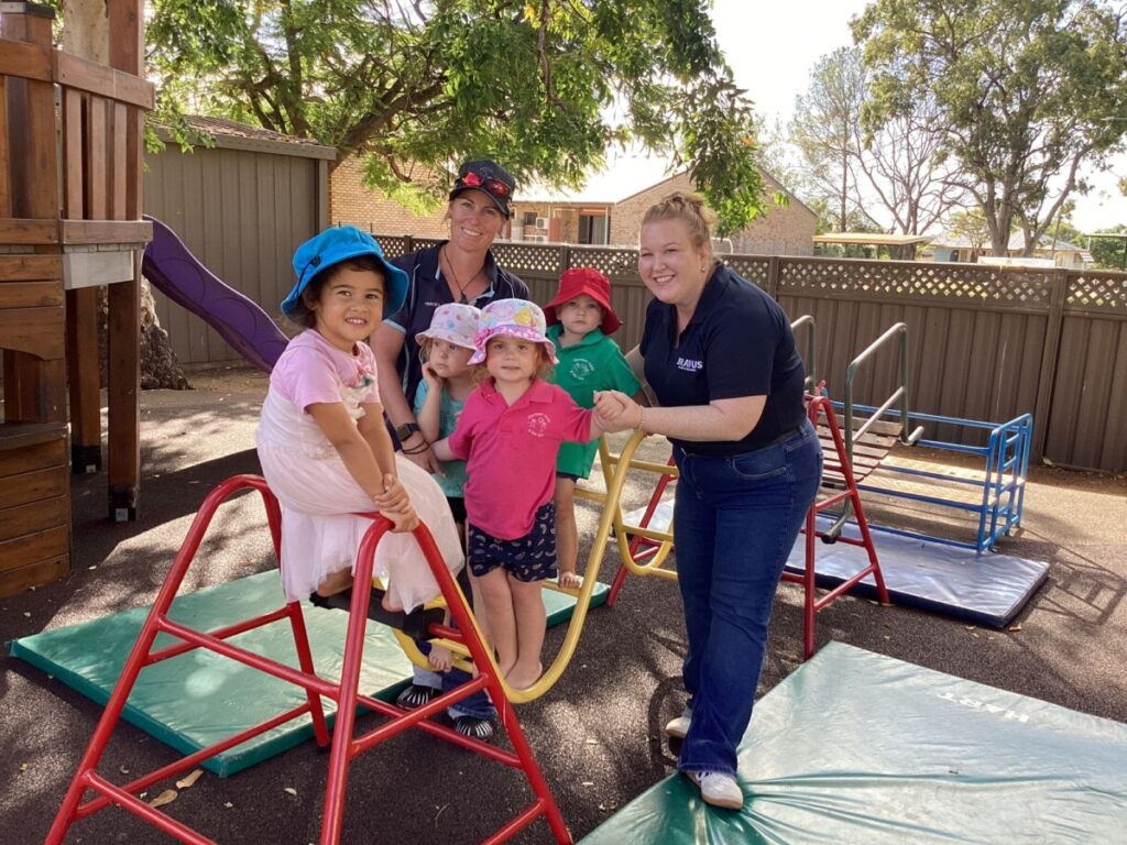 (Image source: Bravus Mining and Resources) Bravus Mining and Resources communications and community relations advisor Tanya Brown with the children at Clermont Kindergarten and Day Care Centre.